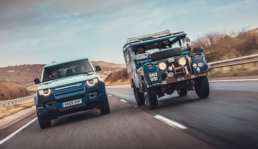 Close-up of a new and old LandRover model from behind on the highway